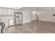 Open-concept living space featuring wood-look flooring, natural light, and kitchen access at 4745 Madrigal Way, Las Vegas, NV 89122