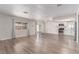Spacious living room with wood-look flooring, natural light, and an open floorplan at 4745 Madrigal Way, Las Vegas, NV 89122