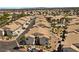 Scenic aerial view of a housing development featuring community pool, landscaping and palm trees at 4821 Black Bear Rd # 101, Las Vegas, NV 89149