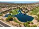 Scenic aerial view of a neighborhood with a lake, golf course, and mature trees at 4821 Black Bear Rd # 101, Las Vegas, NV 89149