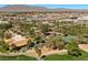Overhead view of community club house with tennis courts, lush trees, landscaping and mountain views at 4821 Black Bear Rd # 101, Las Vegas, NV 89149
