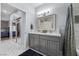 Double vanity bathroom with a view into the bedroom with sliding glass doors at 4821 Black Bear Rd # 101, Las Vegas, NV 89149