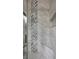 Close up of modern glass enclosed shower with white marble tile and decorative accent tile at 4821 Black Bear Rd # 101, Las Vegas, NV 89149