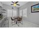 Bright breakfast nook with a modern ceiling fan, plantation shutters, and sleek marble-look tile at 4821 Black Bear Rd # 101, Las Vegas, NV 89149