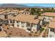 Townhome exteriors with balconies, tile roofs, and a lush landscaped community at 4821 Black Bear Rd # 101, Las Vegas, NV 89149