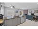 Kitchen with gray cabinets, granite countertops and open living space at 4821 Black Bear Rd # 101, Las Vegas, NV 89149