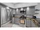 Kitchen featuring stainless steel appliances, gray cabinets and ample counter space at 4821 Black Bear Rd # 101, Las Vegas, NV 89149