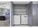 Convenient laundry closet including a washer and dryer, and shelving at 4821 Black Bear Rd # 101, Las Vegas, NV 89149