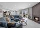 Cozy living area with fireplace, plush blue sofa and balcony with outside view at 4821 Black Bear Rd # 101, Las Vegas, NV 89149