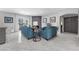 Bright living room featuring blue sofas, modern fireplace, and balcony access at 4821 Black Bear Rd # 101, Las Vegas, NV 89149