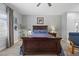 This main bedroom has hard wood floors, a fan, and large windows at 4821 Black Bear Rd # 101, Las Vegas, NV 89149