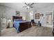 Relaxing main bedroom with decor wallpaper, hardwood floors, and a ceiling fan at 4821 Black Bear Rd # 101, Las Vegas, NV 89149