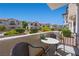 Private patio with table and chairs with a view of the lush landscaping and community at 4821 Black Bear Rd # 101, Las Vegas, NV 89149