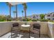 Private patio with table and chairs with a view of the lush landscaping and community pool at 4821 Black Bear Rd # 101, Las Vegas, NV 89149