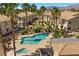 Inviting community pool with spa surrounded by palm trees and well maintained landscaping in Painted Desert at 4821 Black Bear Rd # 101, Las Vegas, NV 89149