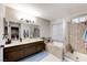 Bathroom featuring double sinks, a soaking tub, and separate glass enclosed shower at 4835 Illustrious St, Las Vegas, NV 89147