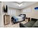 Comfortable bedroom featuring a soft couch and shutters for privacy and light control at 4835 Illustrious St, Las Vegas, NV 89147