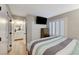 Relaxing bedroom with wood floors, plantation shutters, and an ensuite bathroom at 4835 Illustrious St, Las Vegas, NV 89147