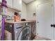 Laundry room featuring front-load washer and dryer, along with white cabinets and laminate countertops at 4835 Illustrious St, Las Vegas, NV 89147