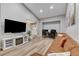 Inviting living room with wood floors, a tan couch, fireplace, and a view of the staircase at 4835 Illustrious St, Las Vegas, NV 89147
