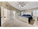 This primary bedroom features bright white trim and doors and a large ceiling fan at 4835 Illustrious St, Las Vegas, NV 89147