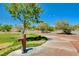 Lush park setting with a water fountain surrounded by green grass and walking paths at 4835 Illustrious St, Las Vegas, NV 89147