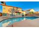 View of sparkling pool with tiled border and home exterior featuring shutters at 4835 Illustrious St, Las Vegas, NV 89147