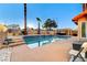 Pool with waterfall feature, hot tub under pergola and desert landscaping at 4835 Illustrious St, Las Vegas, NV 89147