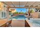 Backyard oasis with pool, hot tub, lounge area, and desert landscaping at 4835 Illustrious St, Las Vegas, NV 89147