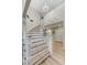 Elegant staircase with wood stairs, white railings, and chandelier at 4835 Illustrious St, Las Vegas, NV 89147
