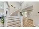 Elegant staircase with wood stairs, white railings, and chandelier at 4835 Illustrious St, Las Vegas, NV 89147