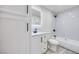 Modern bathroom with white marble tile, illuminated mirror and a shower-tub with sleek black hardware at 5217 Caspian Springs Dr # 101, Las Vegas, NV 89120