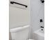 Bathroom showcasing white marble-look shower tile, black hardware, and white toilet at 5217 Caspian Springs Dr # 101, Las Vegas, NV 89120