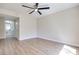 Bright bedroom with ceiling fan, neutral walls, wood-look flooring, and attached bath at 5217 Caspian Springs Dr # 101, Las Vegas, NV 89120