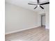 Bright bedroom with ceiling fan and light, neutral walls, and wood-look flooring at 5217 Caspian Springs Dr # 101, Las Vegas, NV 89120