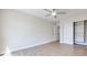 Spacious bedroom with a ceiling fan, wood-style flooring, and a convenient sliding-door closet for ample storage at 5217 Caspian Springs Dr # 101, Las Vegas, NV 89120