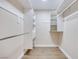 Walk-in closet with custom shelving and wood-look flooring, offering ample storage space at 5217 Caspian Springs Dr # 101, Las Vegas, NV 89120