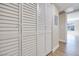 Hallway with ample closet space, featuring shutter doors and wood-style flooring that provides plentiful storage at 5217 Caspian Springs Dr # 101, Las Vegas, NV 89120