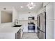 Modern updated kitchen featuring stainless steel appliances and bright white cabinets at 5217 Caspian Springs Dr # 101, Las Vegas, NV 89120