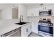 Chic kitchen features stainless appliances, quartz counters and new hardware at 5217 Caspian Springs Dr # 101, Las Vegas, NV 89120