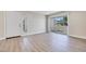 Bright living room boasts new wood-look flooring and sliding glass doors to a private patio at 5217 Caspian Springs Dr # 101, Las Vegas, NV 89120