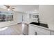 Inviting living room featuring wood-style flooring, neutral paint, and abundant natural light, seamlessly flows into the kitchen at 5217 Caspian Springs Dr # 101, Las Vegas, NV 89120