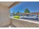 Outdoor patio area overlooking a parking area with mature trees and landscaping at 5217 Caspian Springs Dr # 101, Las Vegas, NV 89120