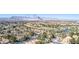 Expansive aerial view showcasing the residential area, a golf course, and a mountain range in the background at 5221 Crooked River Cir, Las Vegas, NV 89149