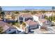 Aerial view of charming two-story home with a well-manicured lawn and landscaping at 5221 Crooked River Cir, Las Vegas, NV 89149