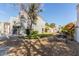 The backyard features a nice wrought iron bench surrounded by a grassy area and mulch with a mature shade tree at 5221 Crooked River Cir, Las Vegas, NV 89149