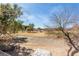 Overlooking desert landscaping and backyard golf course from the private upper patio at 5221 Crooked River Cir, Las Vegas, NV 89149