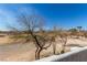 View from the private upper patio overlooking the backyard, trees, and desert landscape at 5221 Crooked River Cir, Las Vegas, NV 89149