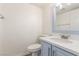 Bathroom with a white toilet and blue vanity featuring a white countertop and stainless steel faucet at 5221 Crooked River Cir, Las Vegas, NV 89149