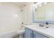 Well lit bathroom featuring a shower over tub, vanity, and light blue cabinet at 5221 Crooked River Cir, Las Vegas, NV 89149